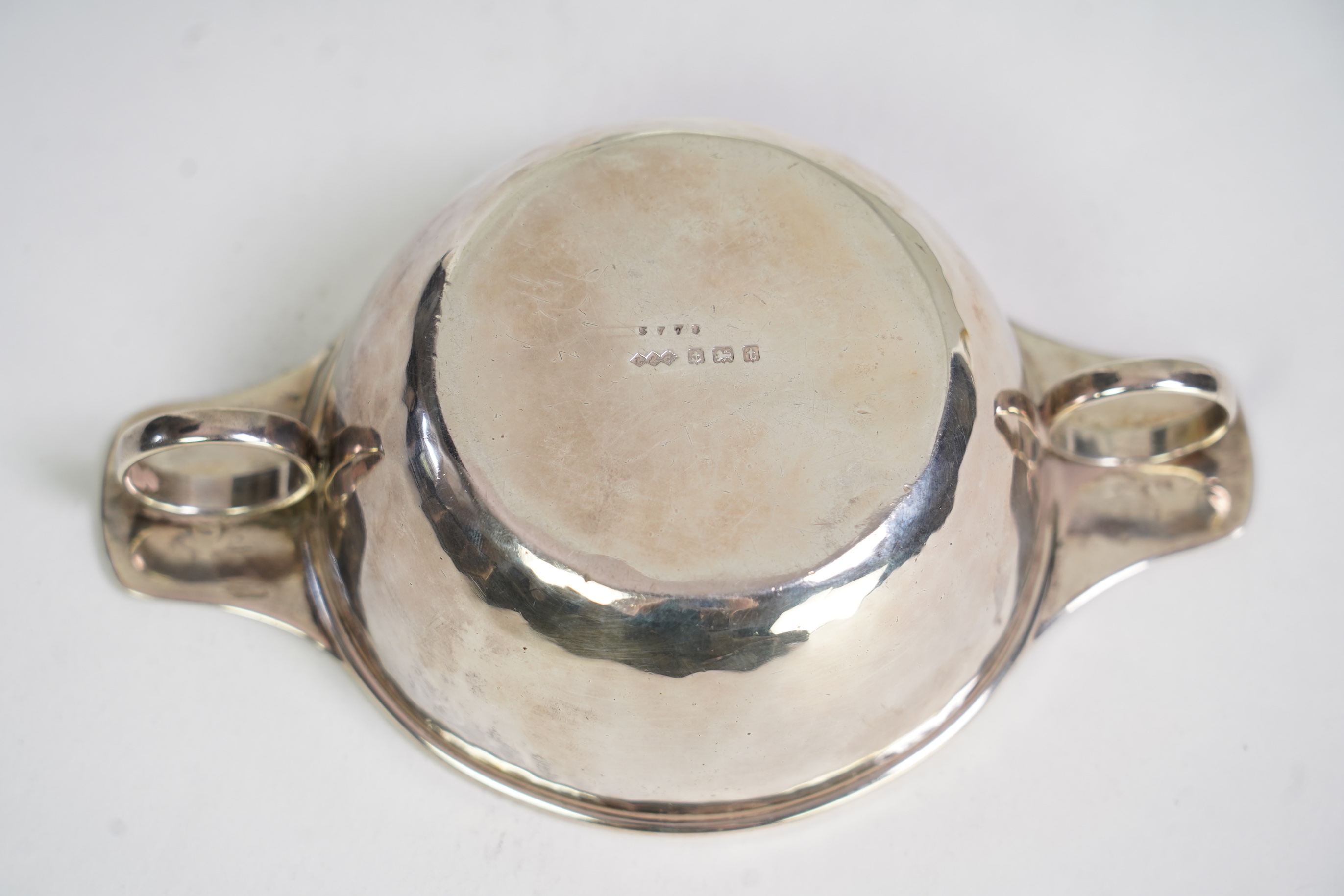 A George V Arts & Crafts Liberty and Co silver porringer